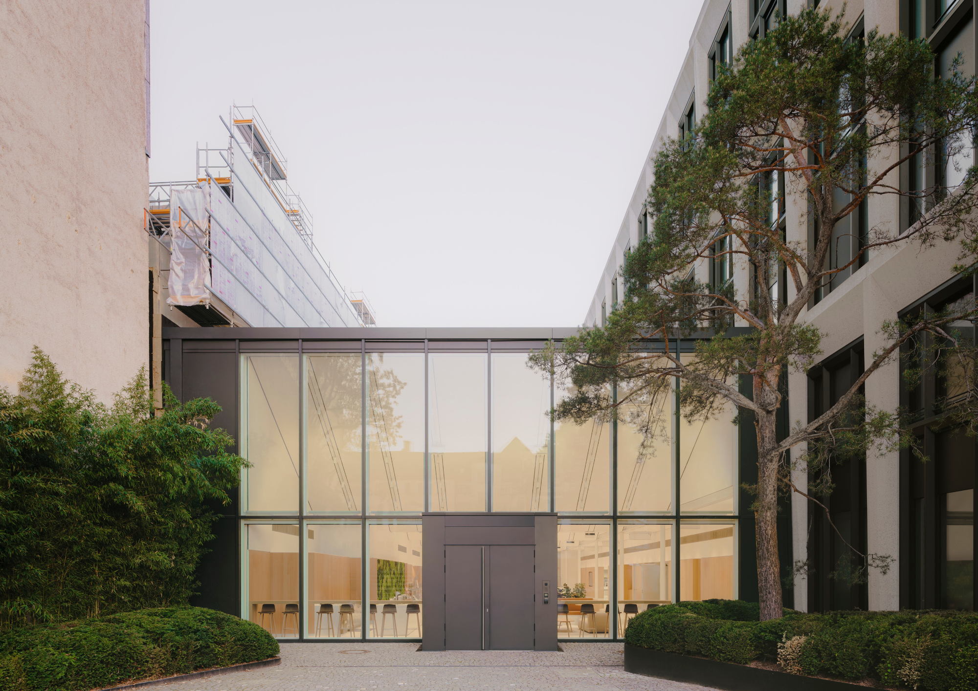 Completed building, Entrance to sawtooth-roof hall, photographed in 2024